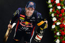 Sebastian Vettel walks off the podium with the spoils of victory