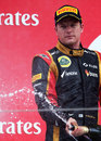 Kimi Raikkonen celebrates on the podium