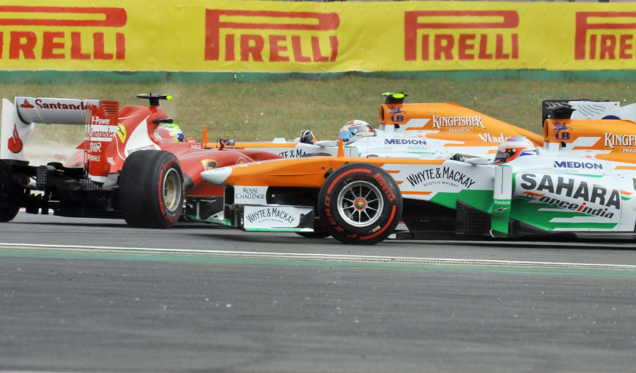 Paul di Resta and Adrian Sutil try to avoid a spinning Felipe Massa