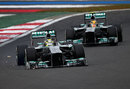 Nico Rosberg's front wing scrapes along the floor after failing as he passed team-mate Lewis Hamilton