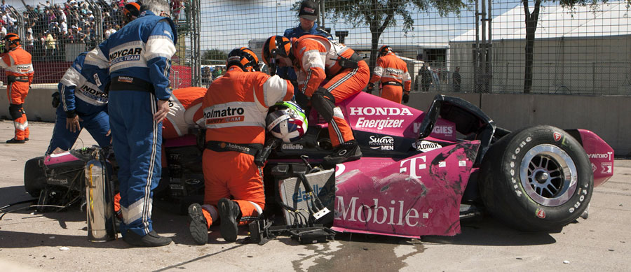 Marshals and medical workers remove Dario Franchitti from his crash