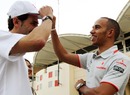 Lewis Hamilton shares a joke with Pedro de la Rosa