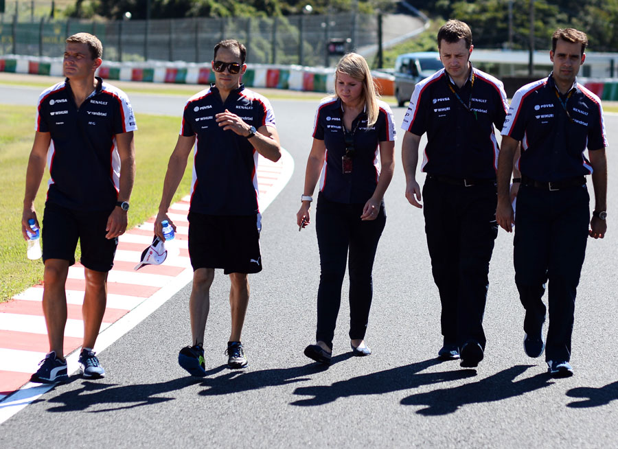 Pastor Maldonado walks the track with his Williams team