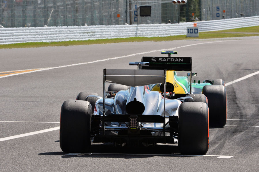 A Sauber and Caterham leave the pits