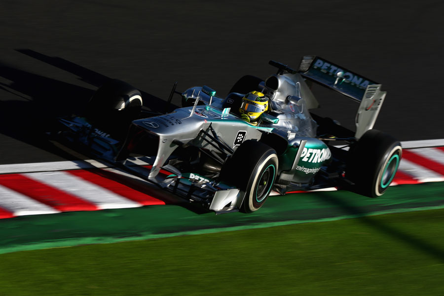 Nico Rosberg uses all of the kerbs and a bit more