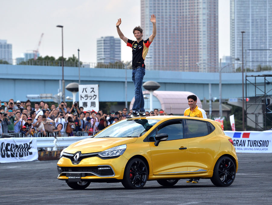 Romain Grosjean waves to the crowd at the Motor Sports Japan event