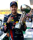 Sebastian Vettel celebrates with his trophy