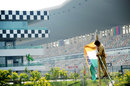 A track worker raises the Indian flag