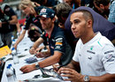 Lewis Hamilton alongside Mark Webber at the driver autograph session