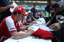 Fernando Alonso signs autographs for Indian fans
