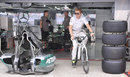 Nico Rosberg cycles out of the Mercedes garage