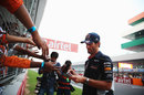 Mark Webber signs autographs for fans in the main grandstand