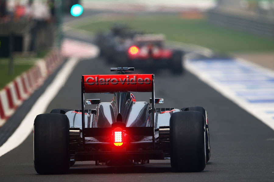 Jenson Button heads down the pit lane