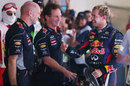 Adrian Newey and Christian Horner greet Sebastian Vettel in parc ferme after his victory