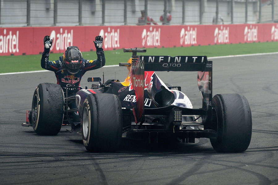 Sebastian Vettel bows down to his RB9 after the race