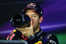 Sebastian Vettel swigs his champagne in the driver press conference