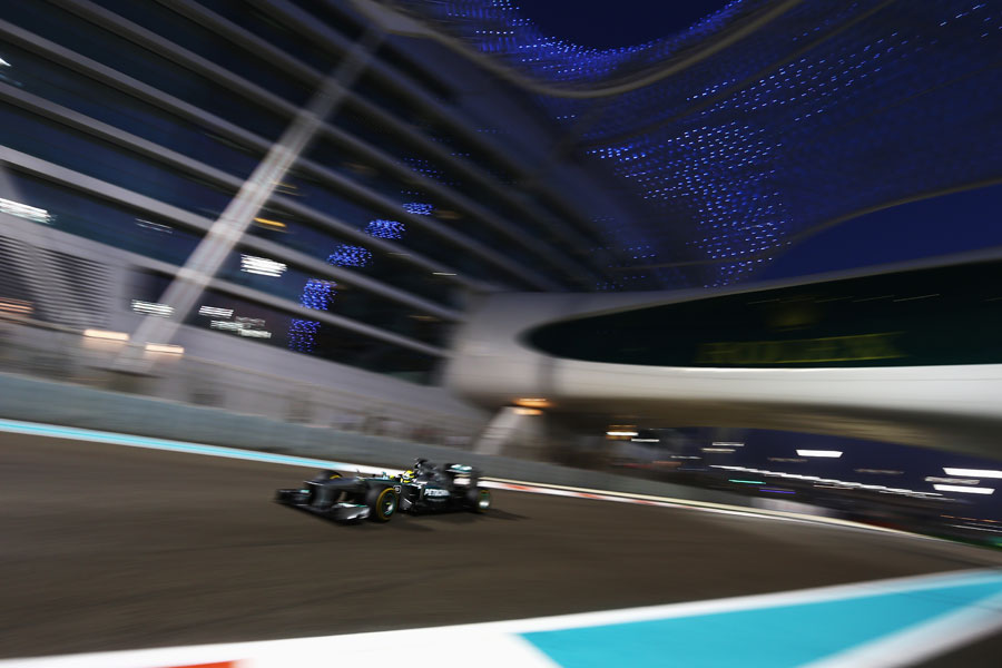 Nico Rosberg passes under the Yas Hotel