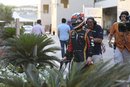 Kimi Raikkonen returns to the paddock after retiring on the opening lap