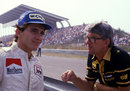 Ayrton Senna talks to Lotus team manager Peter Warr on the pit wall