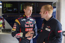 Daniil Kvyat chats with an engineer in the Toro Rosso garage