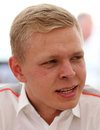 McLaren driver Kevin Magnussen watches on from the pit wall