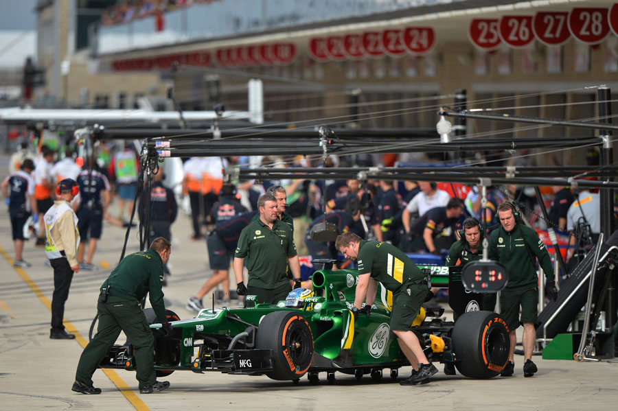 Charles Pic is wheeled back in to the Caterham garage