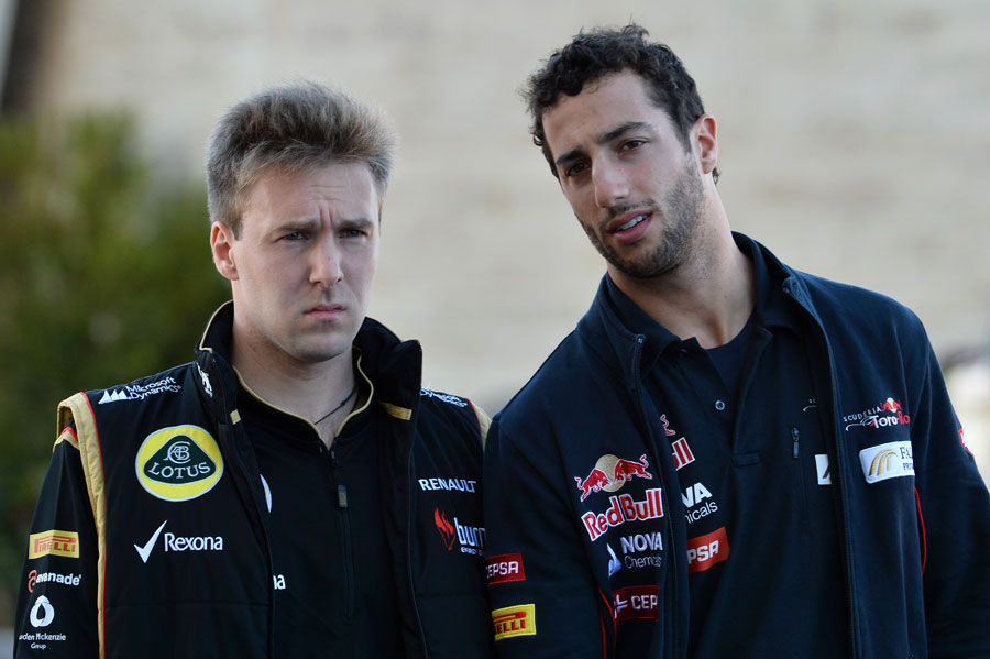 Davide Valsecchi walks through the paddock with Daniel Ricciardo