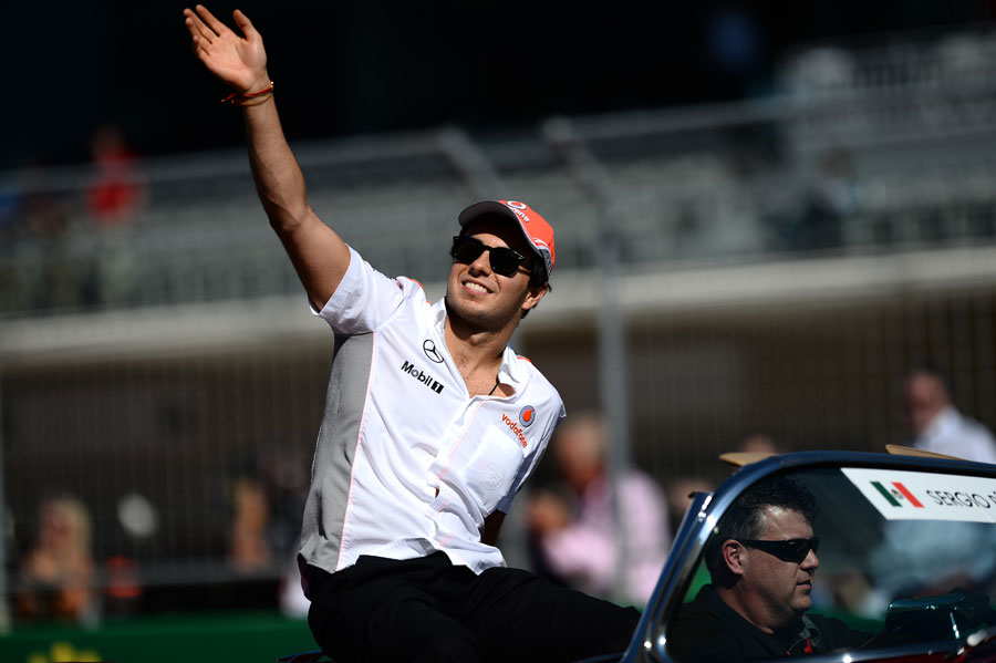 Sergio Perez waves to the crowds on the drivers' parade