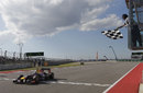 Sebastian Vettel crosses the line to take victory