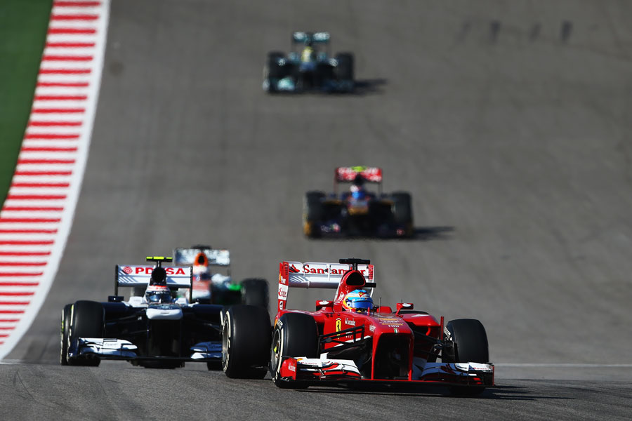 Fernando Alonso leads Valtteri Bottas early in the race