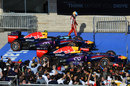 Fernando Alonso walks past the two Red Bulls in parc ferme