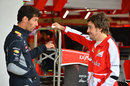 Mark Webber and Fernando Alonso chat during a delay ahead of FP1