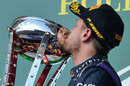 Sebastian Vettel kisses the trophy on the podium