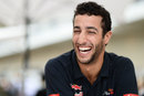 Daniel Ricciardo shares a joke with journalists in the paddock