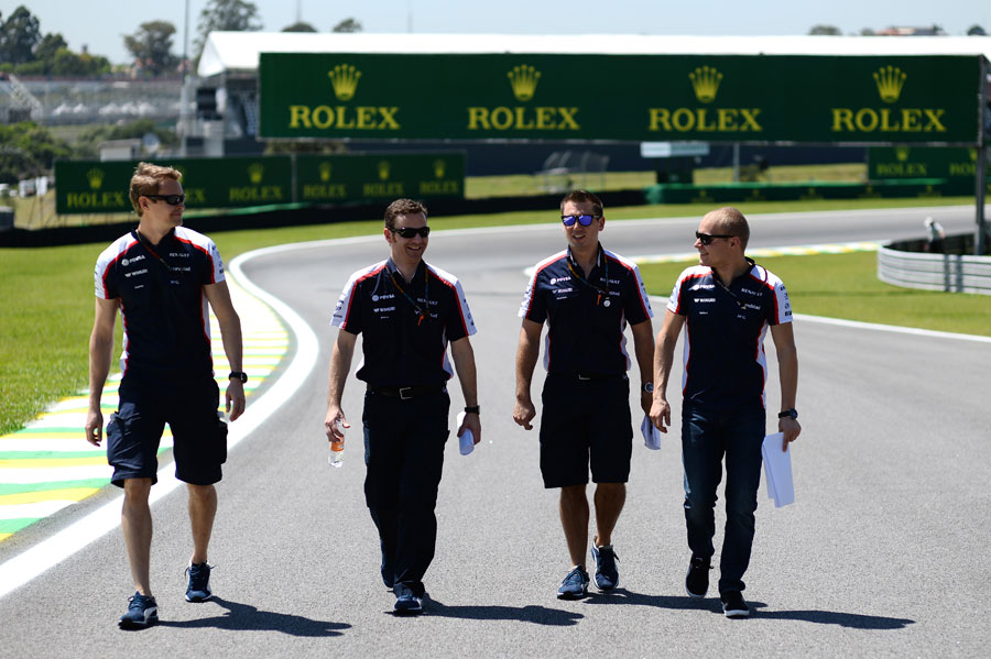Valtteri Bottas walks the track with his Williams engineers