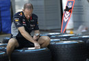 A Red Bull mechanic prepares wet weather tyres