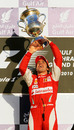 Fernando Alonso carries a trophy