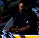 Football legend Pele mistakenly waves the chequered flag for Takuma Sato, one lap behind the leader