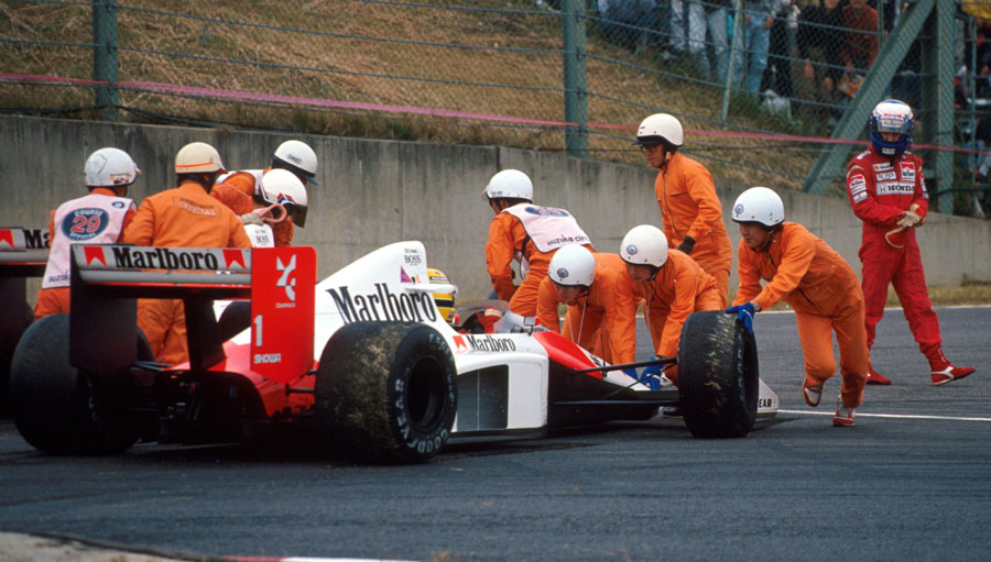 Alain Prost walks from his car following a collision with team-mate Ayrton Senna at the entrance to the chicane