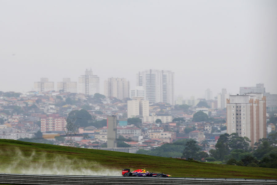 Mark Webber leaves a plume of spray during FP2