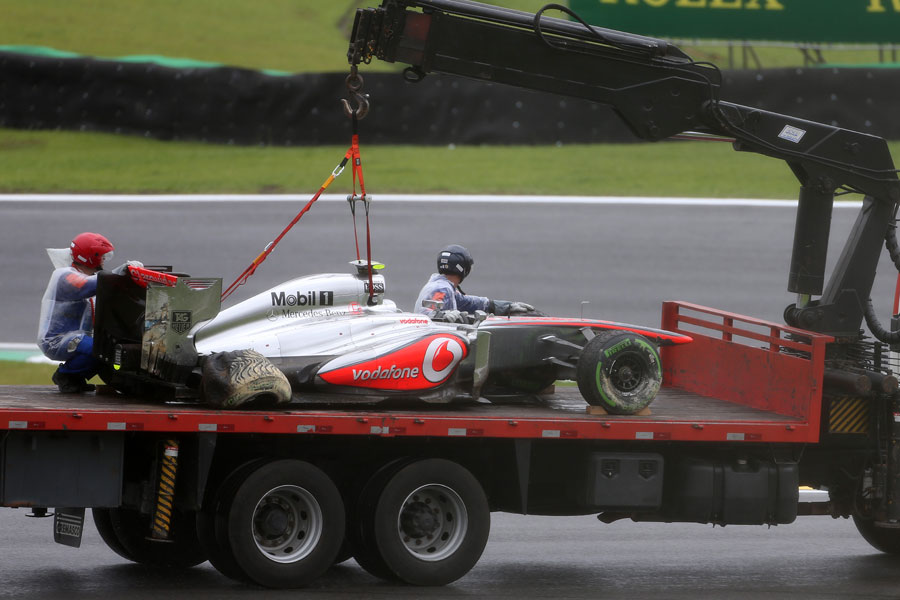 Sergio Perez's damaged McLaren returns to the pits