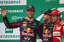 Mark Webber waves to the crowd on the podium alongside Sebastian Vettel and Fernando Alonso