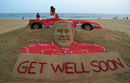 An Indian sand artist puts the final touches on his tribute to Michael Schumacher