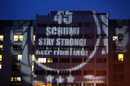 Fans project a message for Michael Schumacher on his 45th birthday on to the outside of the hospital in Grenoble