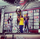Vitantonio Liuzzi celebrates his victory in Felipe Massa's karting event alongside Sebastien Buemi and Massa