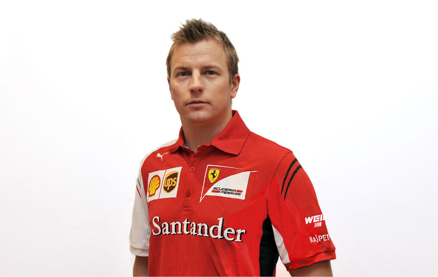 Kimi Raikkonen poses in Ferrari team clothing