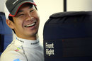 Kamui Kobayashi hugs his tyre warmers in the garage