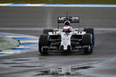 Jenson Button picks his way through puddles on the first day of testing