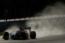 The VJM07 of Sergio Perez navigates through the spray