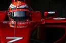 Kimi Raikkonen waits in the cockpit of the F14 T